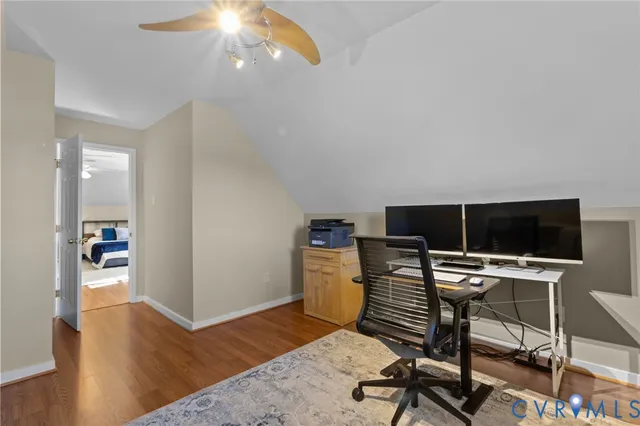 a view of a workspace with furniture and wooden floor