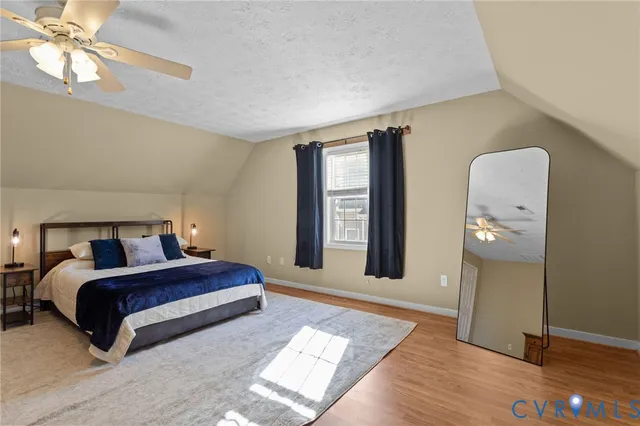 a spacious bedroom with a bed and a chandelier