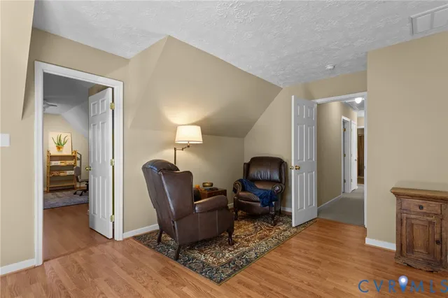 a living room with furniture rug and wooden floor