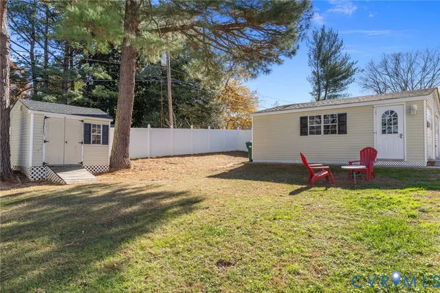 a view of a house with backyard and sitting area