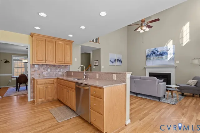 a kitchen with a sink cabinets and wooden floor