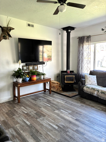 175 Eagle Street Eureka, UT 84628 - Photo 9 of 31 Living area a wood stove and plenty of natural light