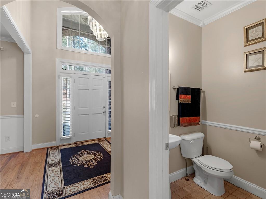 355 Parker Road Covington, GA 30014 - Photo 11 of 60 a bathroom with a toilet a sink and a mirror