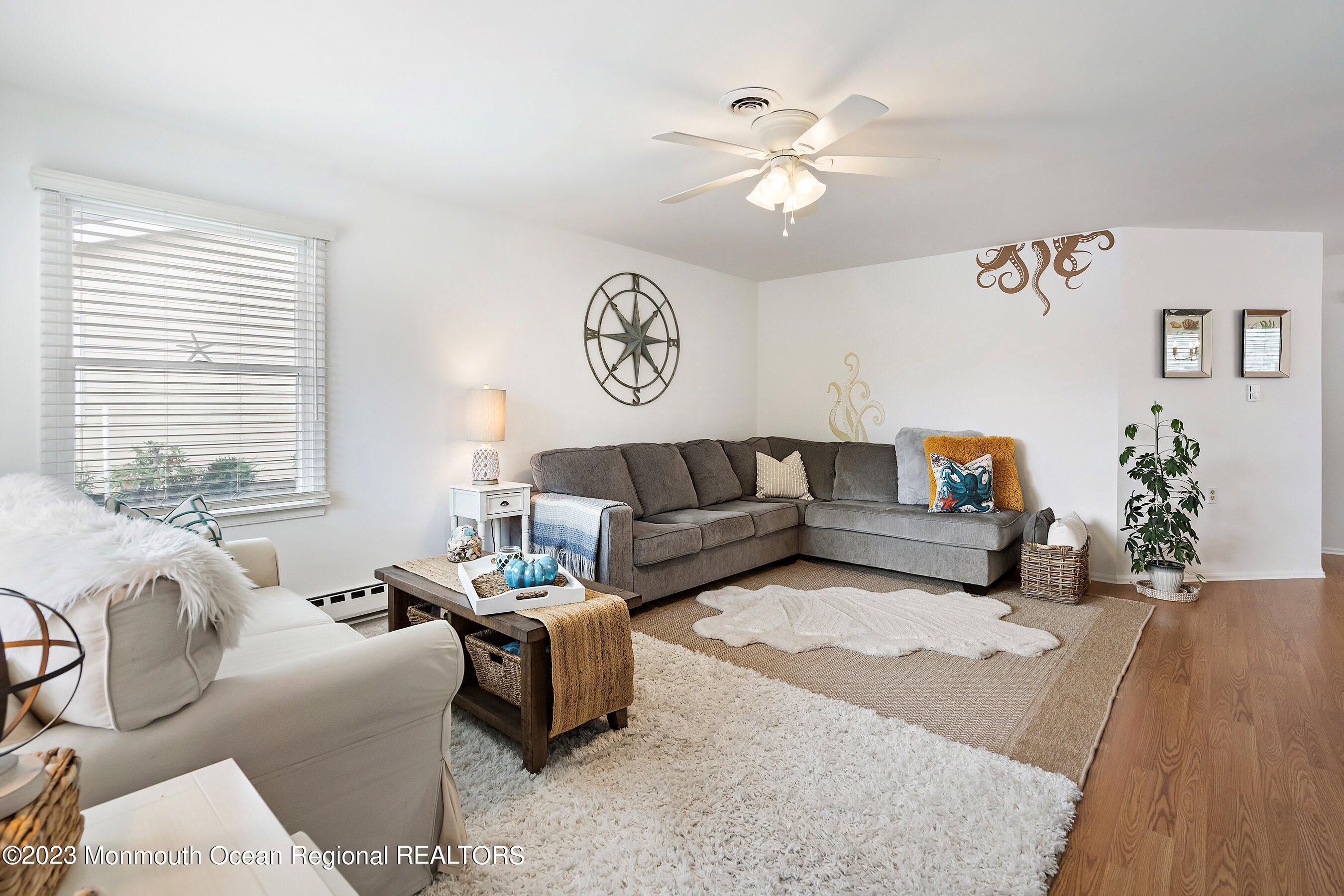60 Sycamore Access Road, Unit 29 Manahawkin, NJ 08050 - Photo 3 of 24 a living room with furniture and a large window