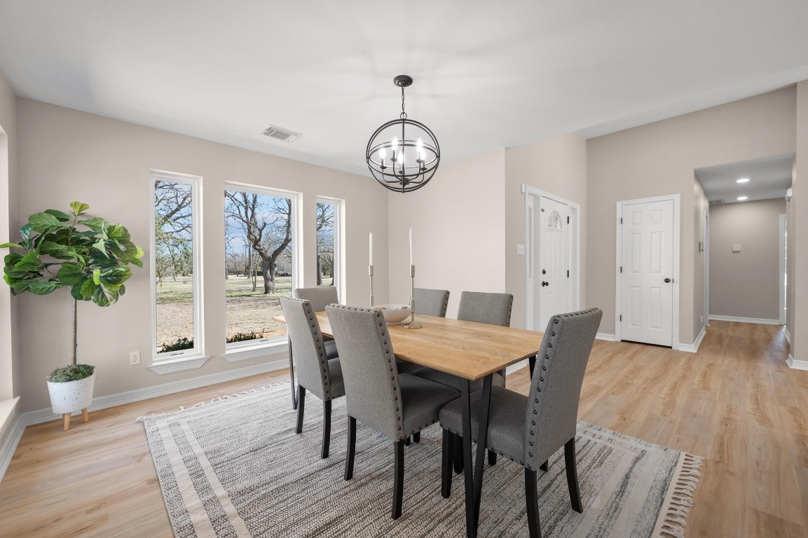 201 Young Ranch Road Georgetown, TX 78633 - Photo 13 of 40 a view of a dining room with furniture window and wooden floor