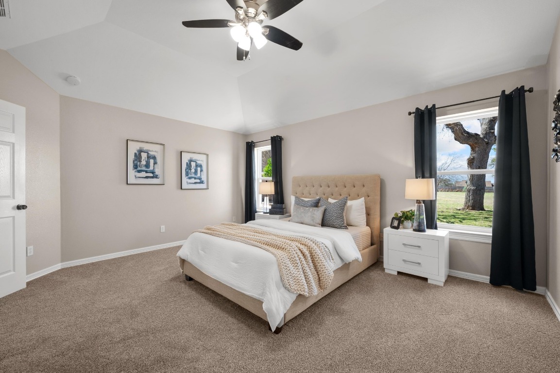 201 Young Ranch Road Georgetown, TX 78633 - Photo 15 of 40 a bed room with a bed and a chandelier