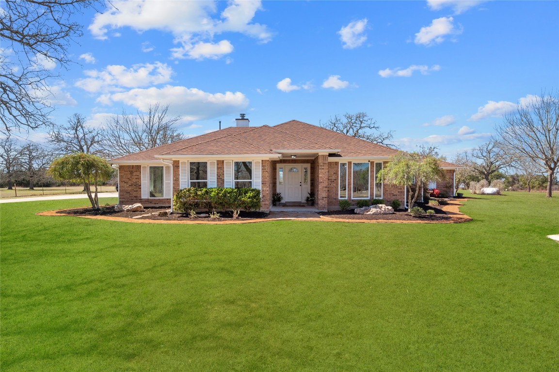 201 Young Ranch Road Georgetown, TX 78633 - Photo 2 of 40 a front view of a house with a yard table and chairs