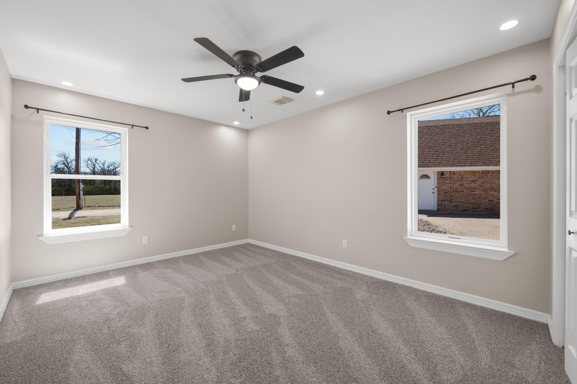 201 Young Ranch Road Georgetown, TX 78633 - Photo 22 of 40 an empty room with a window and a fan