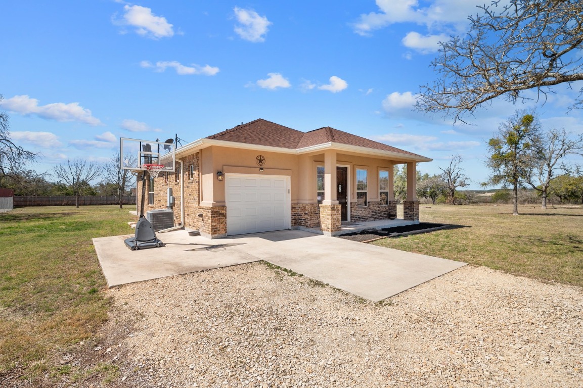 201 Young Ranch Road Georgetown, TX 78633 - Photo 26 of 40 a view of a house with backyard and sitting area