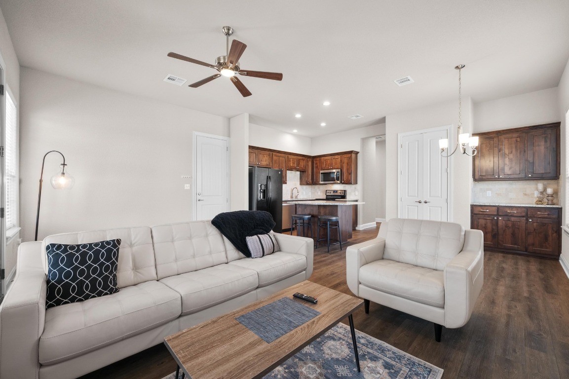 201 Young Ranch Road Georgetown, TX 78633 - Photo 30 of 40 a living room with furniture kitchen view and a chandelier