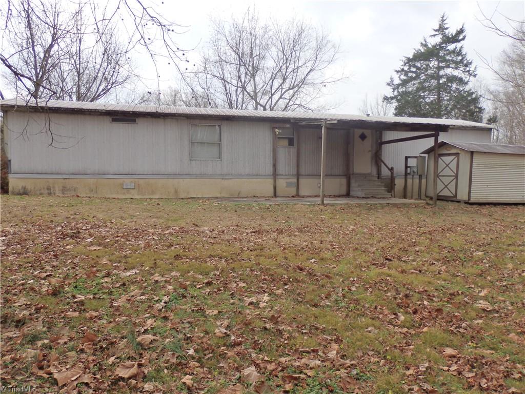 1018 Sutton Road Greensboro, NC 27406 - Photo 35 of 47 Back of mobile home with storage building.