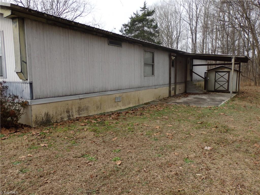 1018 Sutton Road Greensboro, NC 27406 - Photo 37 of 47 Back of mobile home with covered concrete slab.