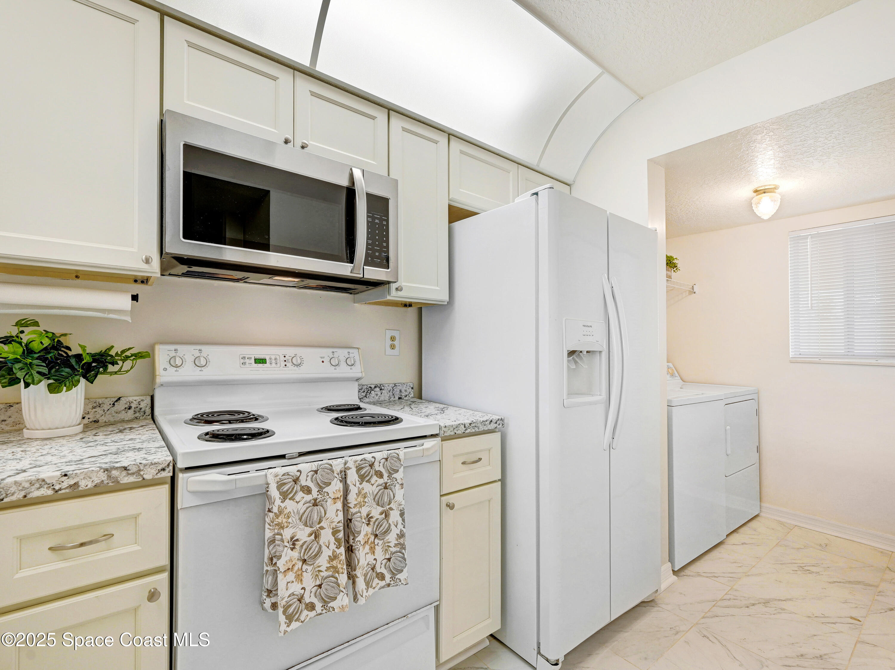 1410 Huntington Lane, Unit 1203 Rockledge, FL 32955 - Photo 15 of 46 Kitchen to Laundry