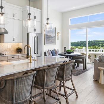5111 Teaberry Lane, Unit 1 Fishkill, NY 12524 - Photo 3 of 7 a dining hall with stainless steel appliances kitchen island granite countertop a table chairs and a view of living room