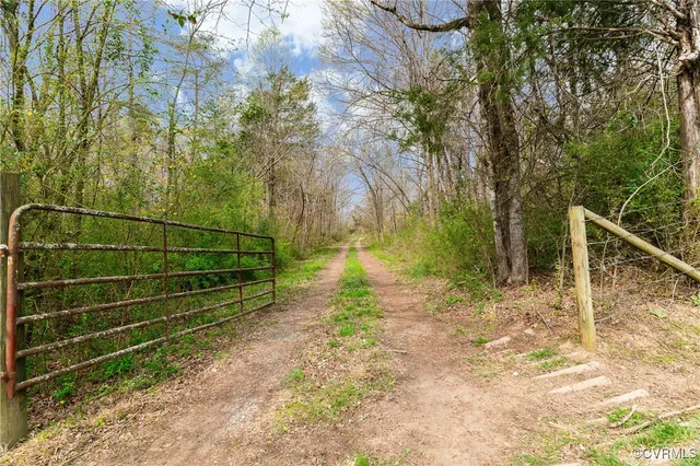 a view of a yard with wooden fence