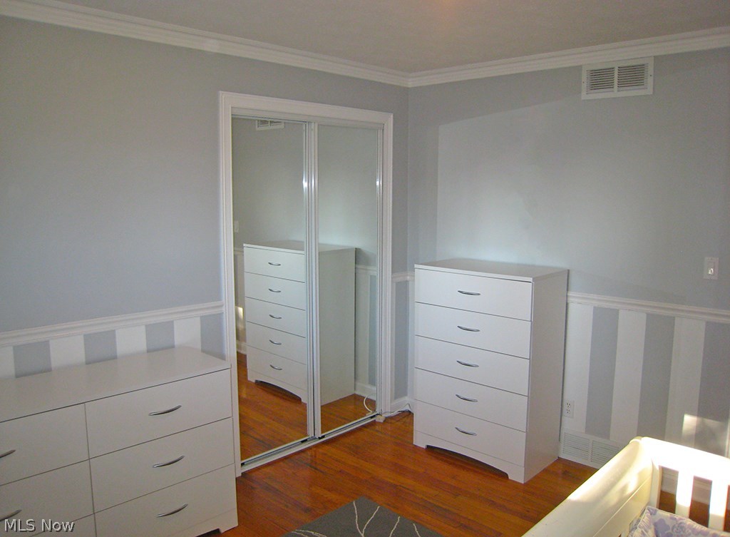 6925 Maplewood Road Parma Heights, OH 44130 - Photo 8 of 25 First bedroom that is bright and open with a oversize closet with mirror doors.