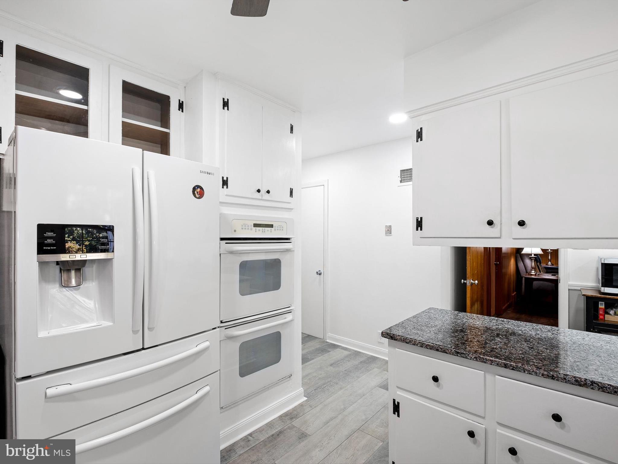 133 Marcella Road Wilmington, DE 19803 - Photo 11 of 27 a kitchen with granite countertop white cabinets and white appliances