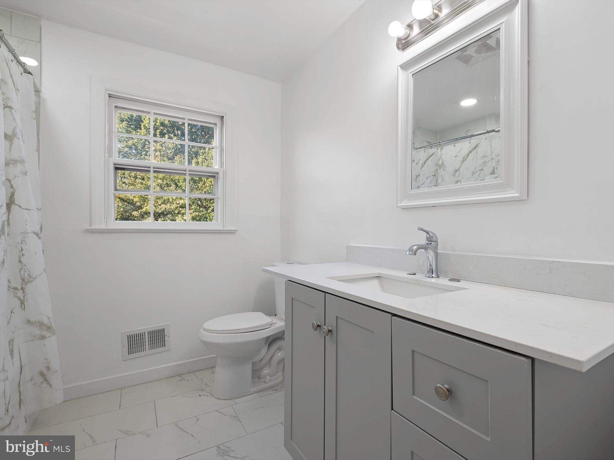 133 Marcella Road Wilmington, DE 19803 - Photo 24 of 27 a bathroom with a toilet sink and mirror