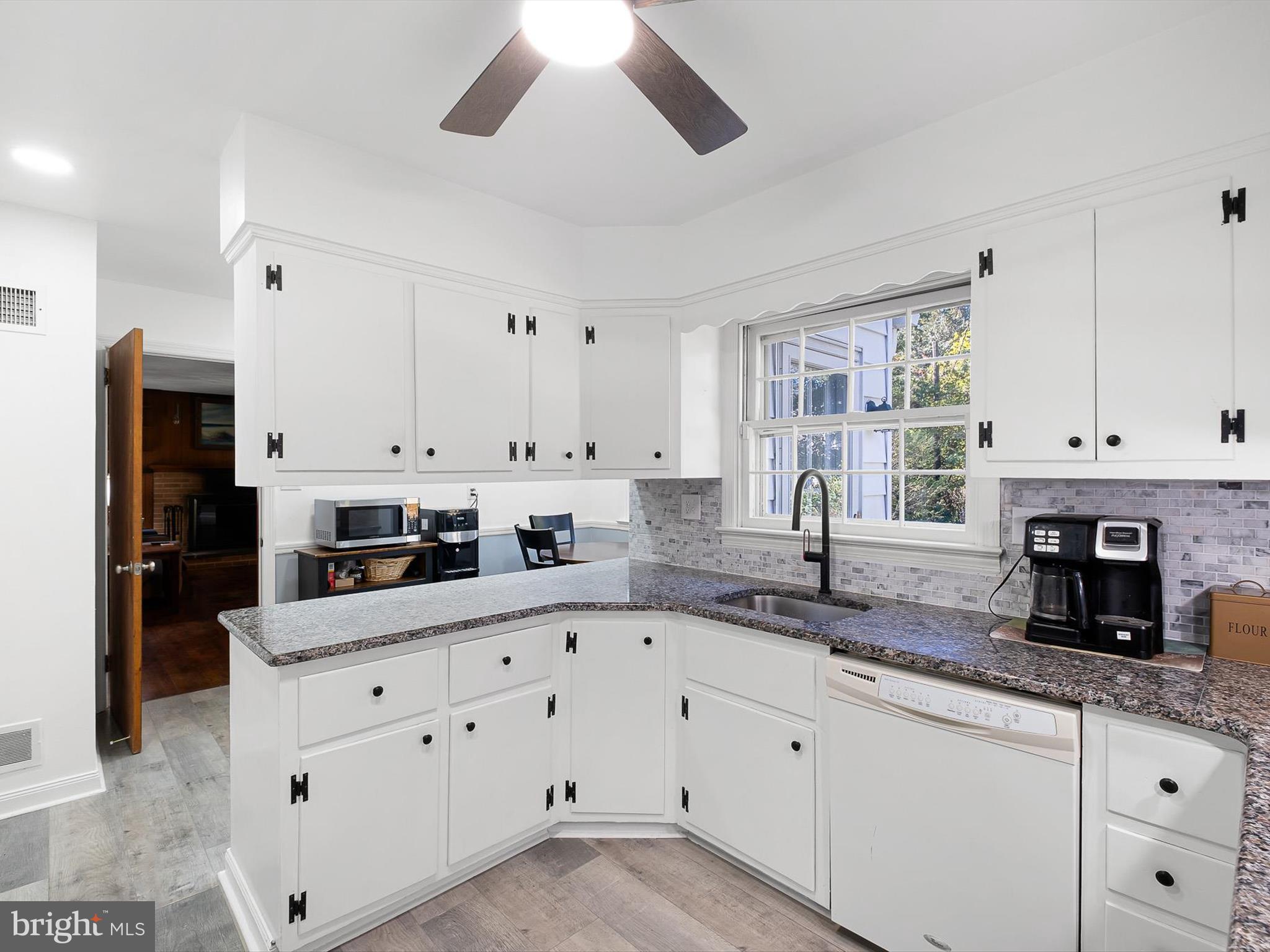 133 Marcella Road Wilmington, DE 19803 - Photo 9 of 27 a kitchen with granite countertop white cabinets and white appliances