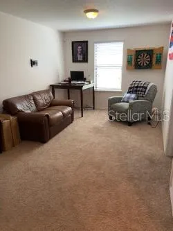 a living room with furniture and a flat screen tv with wooden floor