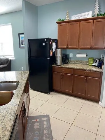 a kitchen with stainless steel appliances granite countertop a refrigerator and a stove