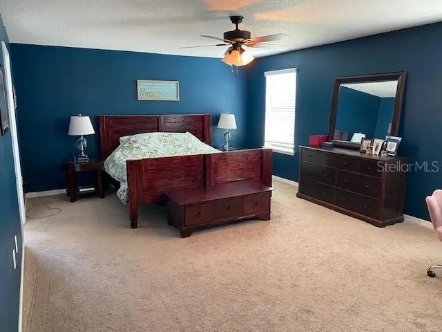 a bed room with a bed and a mirror