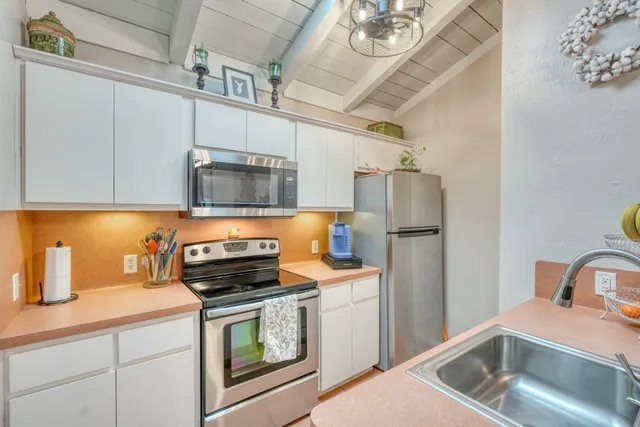 a bedroom with a bed closet and a flat tv screen