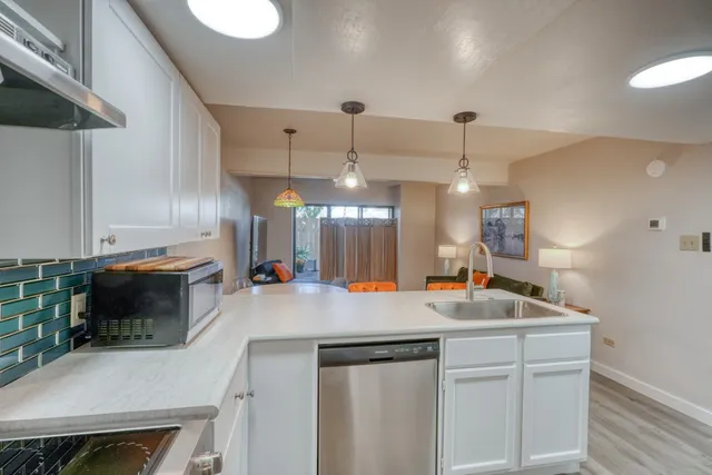 a kitchen with a sink a counter space and appliances