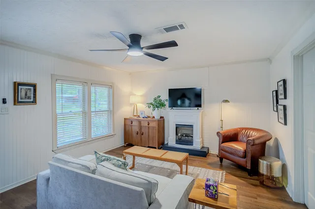 a living room with furniture a fireplace and a flat screen tv