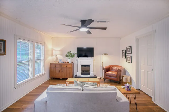 a living room with furniture a fireplace and a flat screen tv