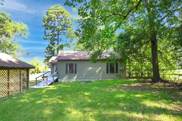 a view of a house with a yard porch and sitting area