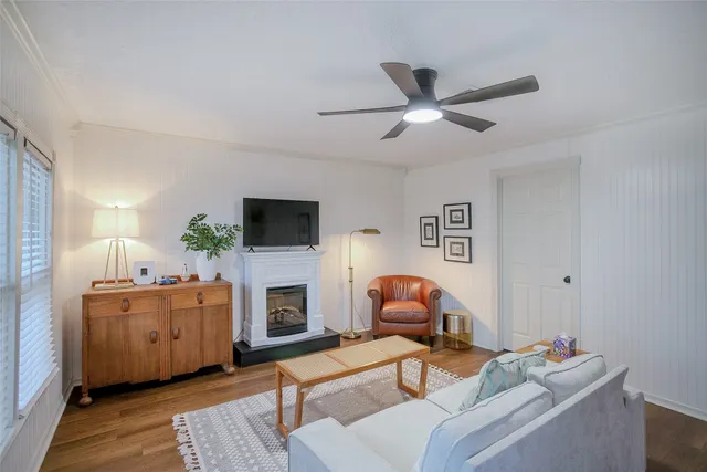a living room with furniture a flat screen tv and a fireplace
