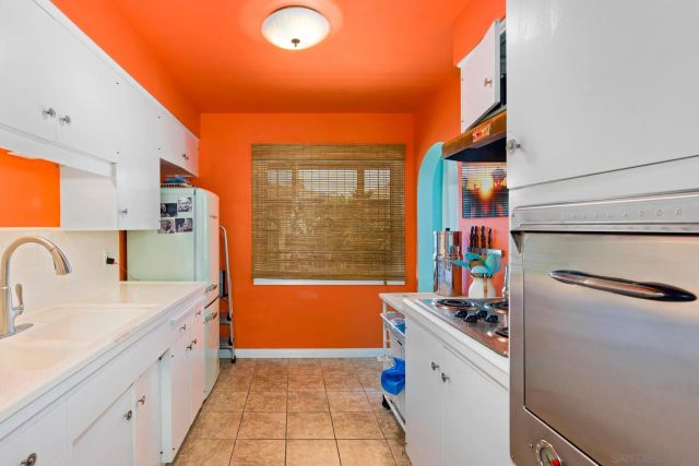 a kitchen that has a sink and a stove in it