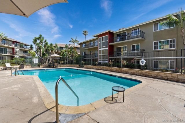 a front view of a house with a yard and potted plants