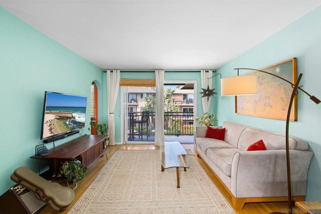 a living room with furniture kitchen view and a table