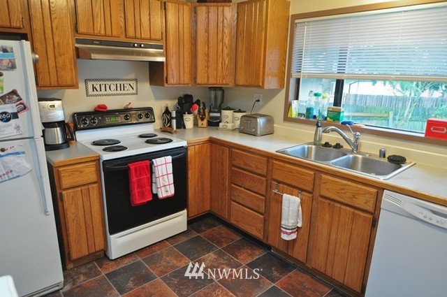 660 Index Place Northeast Renton, WA 98056 - Photo 14 of 18 a kitchen with stainless steel appliances granite countertop a stove a sink and a microwave