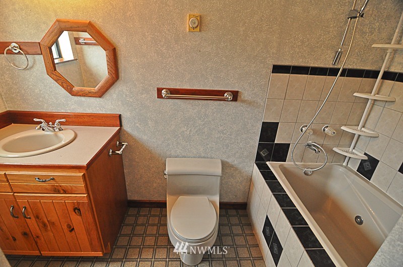 660 Index Place Northeast Renton, WA 98056 - Photo 7 of 18 a bathroom with a toilet a sink and a mirror