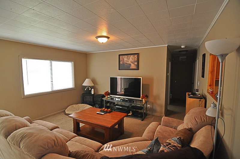 660 Index Place Northeast Renton, WA 98056 - Photo 8 of 18 a living room with furniture a ceiling fan and a window