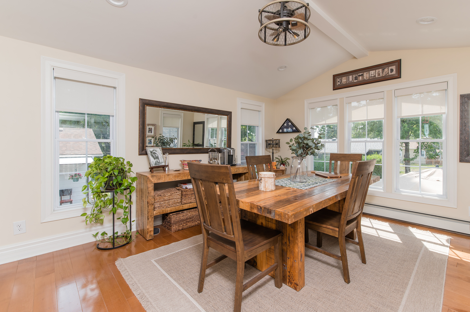 103 Oakleaf Road Lake In The Hills, IL 60156 - Photo 14 of 41 a dining room with furniture potted plants and wooden floor