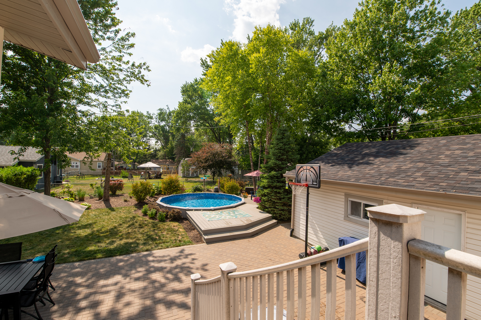 103 Oakleaf Road Lake In The Hills, IL 60156 - Photo 4 of 41 a view of a patio with table and chairs potted plants and large tree