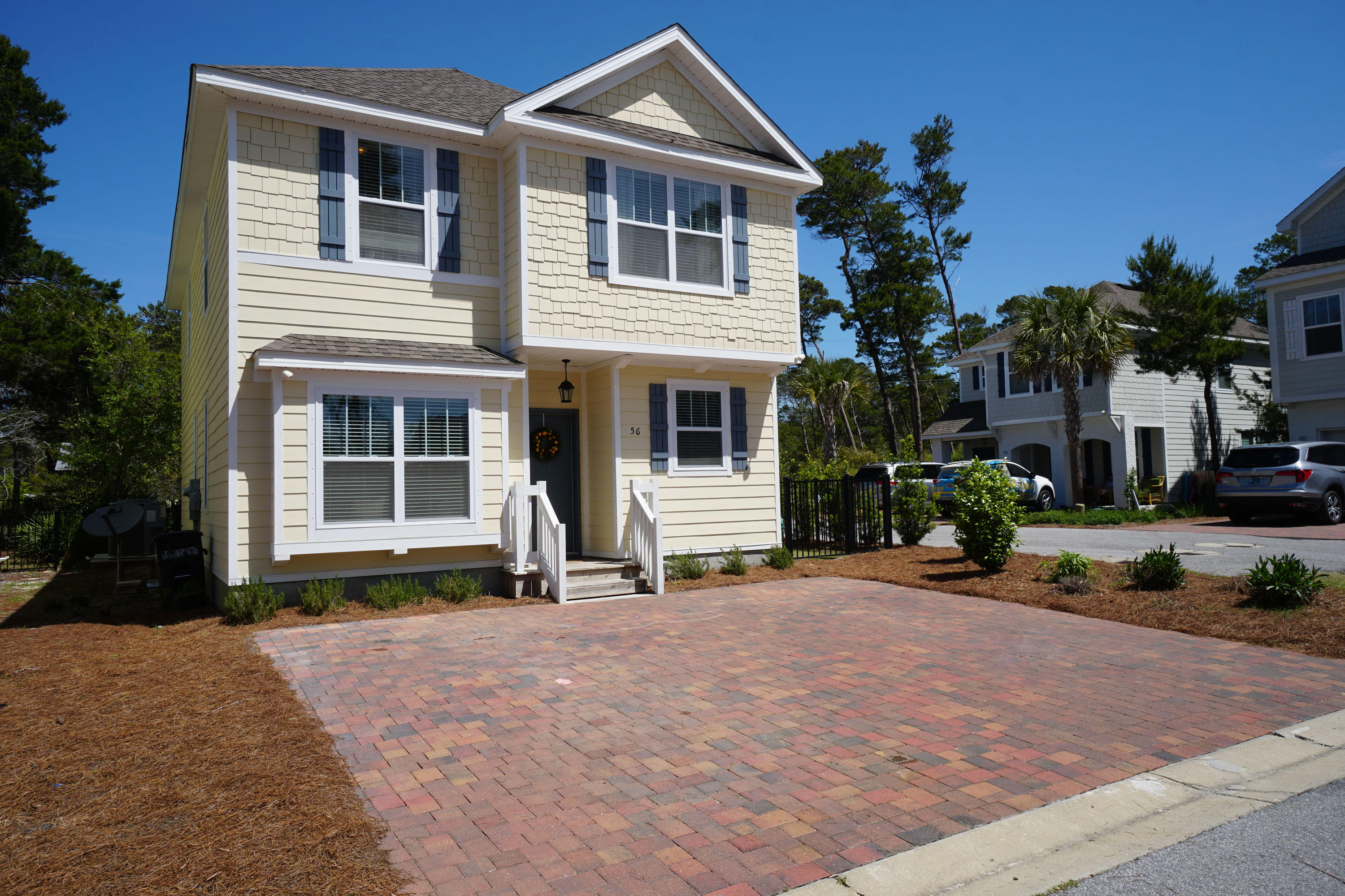 56 Sandpine Loop Inlet Beach, FL 32461 - Photo 1 of 22 a front view of a house with a yard and garage