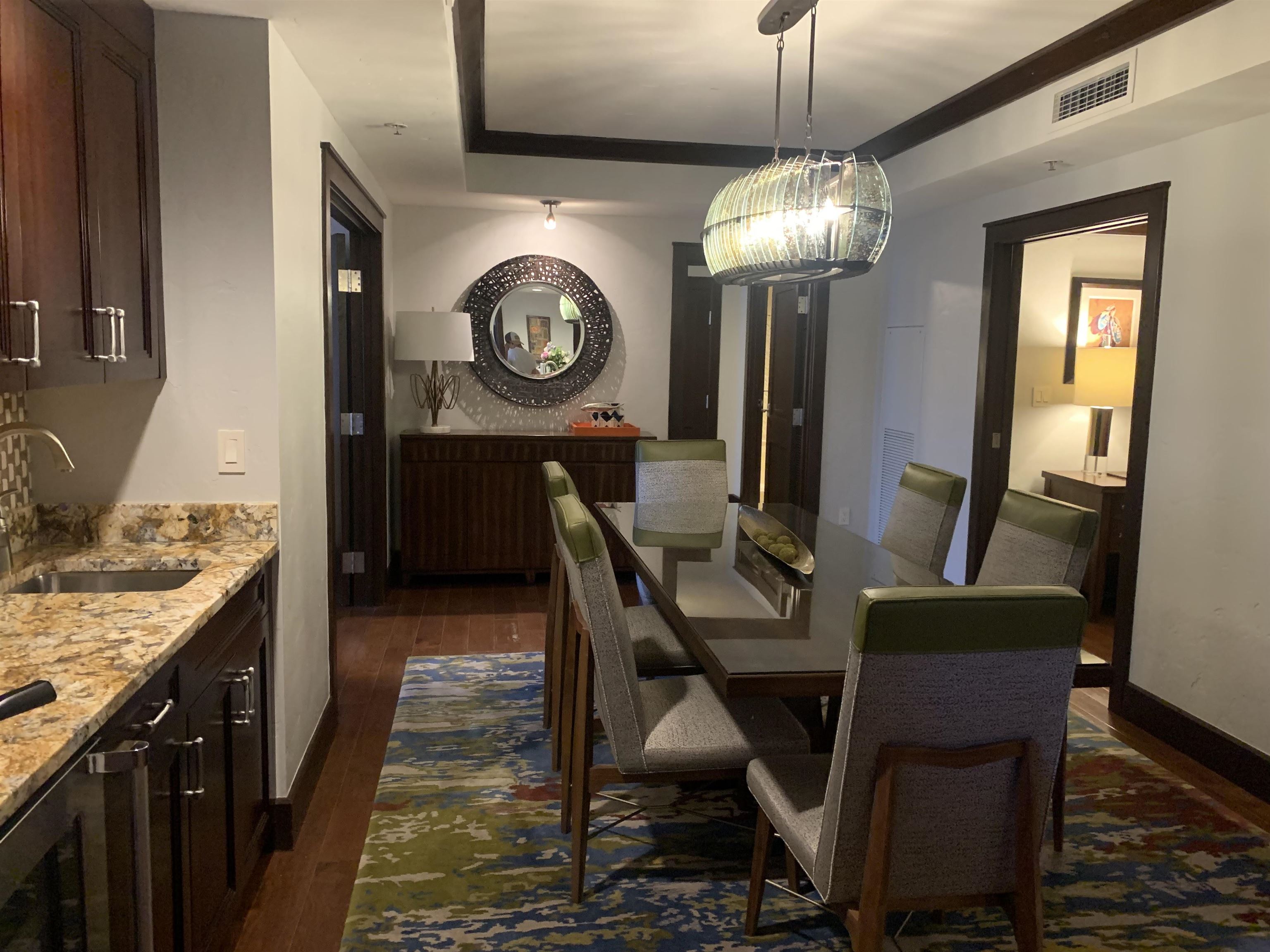 13051 Ritz Carlton Highlands Court, Unit 4304 INTEREST 3 Truckee, CA 96161 - Photo 3 of 12 a view of a dining room and livingroom with furniture wooden floor a rug and a chandelier