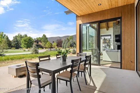 a view of a patio with a backyard dining table and chairs