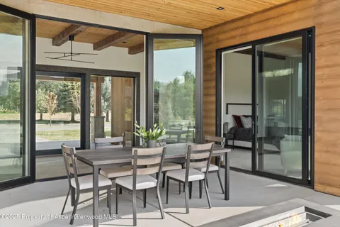 a dining room with furniture and window