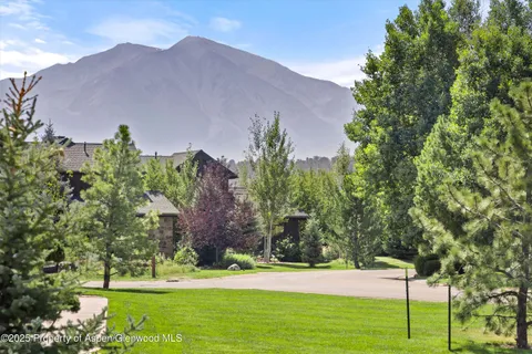 a view of a house with a yard and a garden