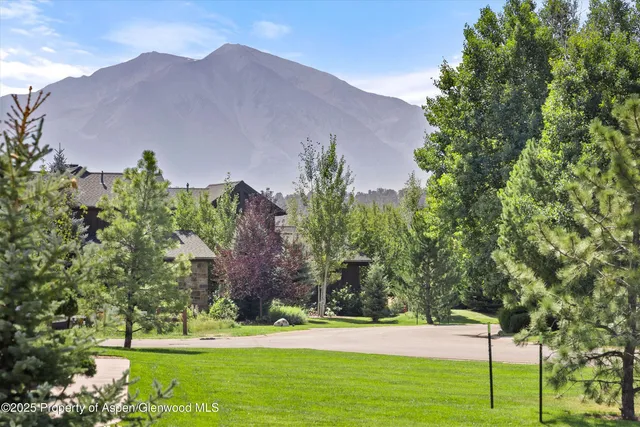 a view of a house with a yard and a garden