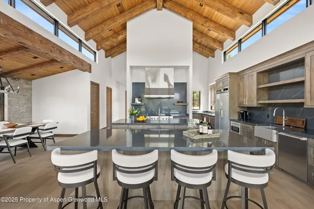 a kitchen with a dining table and chairs
