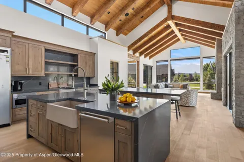 a kitchen with a sink and living room