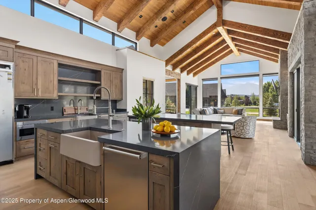 a kitchen with a sink and living room