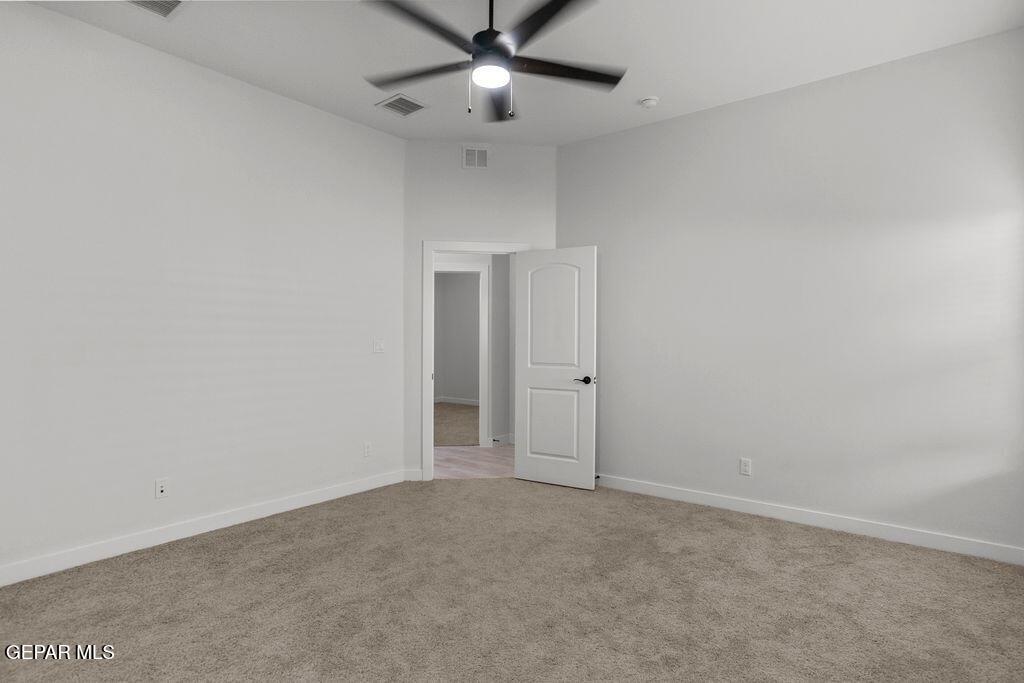 3761 Course Street El Paso, TX 79938 - Photo 9 of 15 an empty room with closet and a chandelier fan